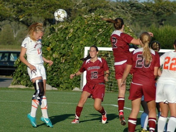 Kaitie clearing the ball with a header off a direct kick.